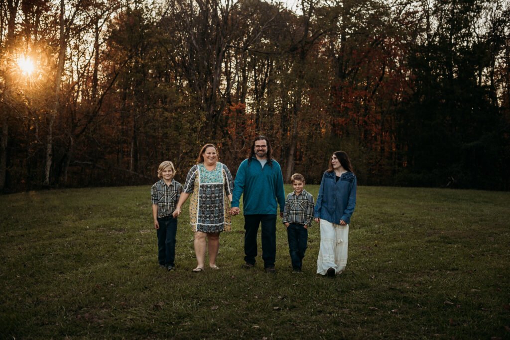 Family standing in front of trees